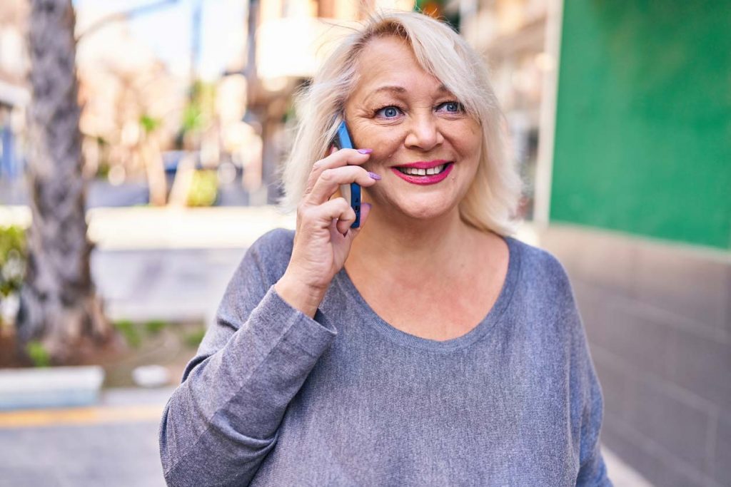 happy woman outside on phone